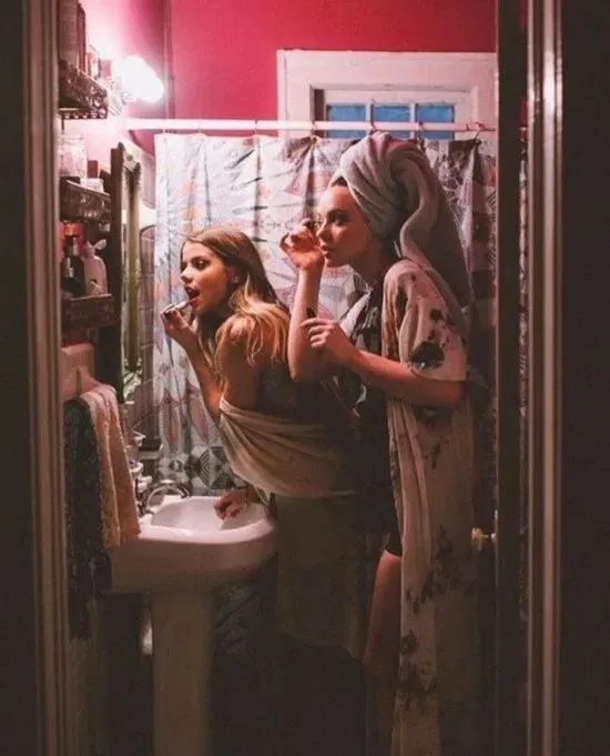 Two roommates laughing in their LA apartment